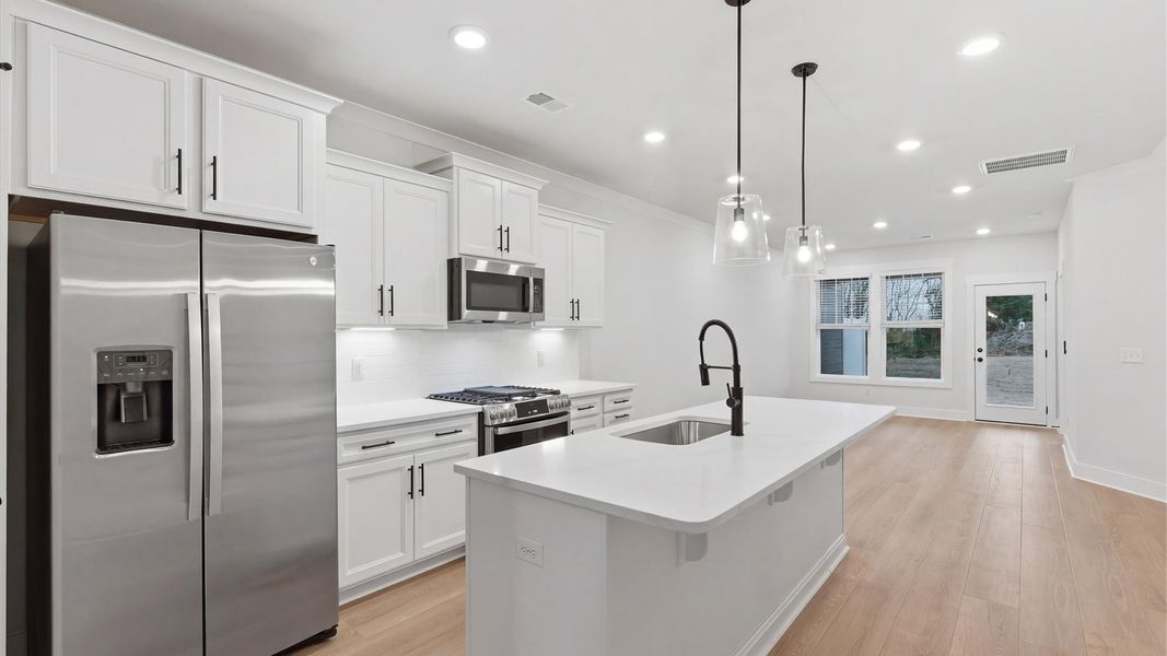 Tasteful kitchen with a streamlined island and modern finishes in a first-class DRB Homes design in Greenville, SC