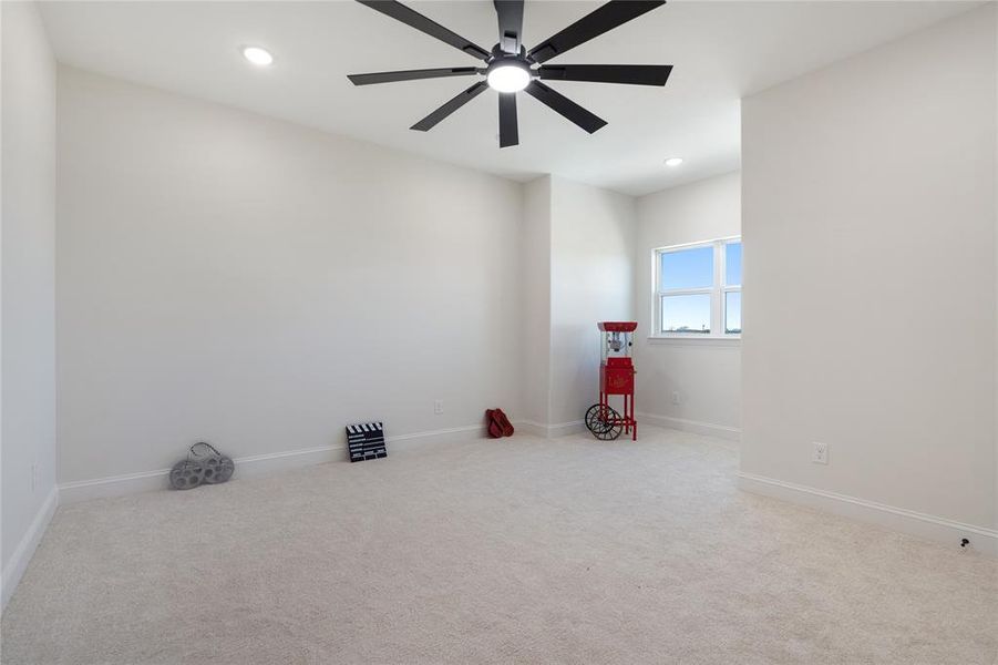 Empty room featuring light carpet and ceiling fan