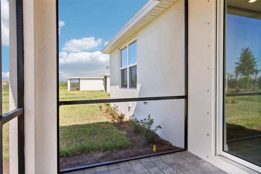 Exterior details and patio area of a home in Crescent Lakes - Premier Series, Punta Gorda (Image 2).