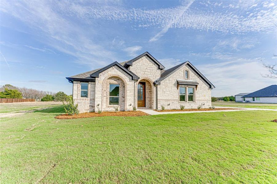 French country style house featuring a front lawn