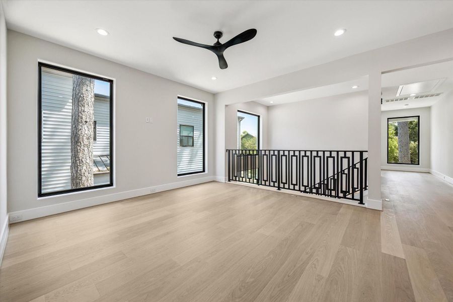 The spacious game room is finished with warm oak flooring, creating an inviting setting ideal for relaxation, play, or entertaining. The spacious game room is finished with warm oak flooring, creating an inviting setting ideal for relaxation, play, or entertaining.