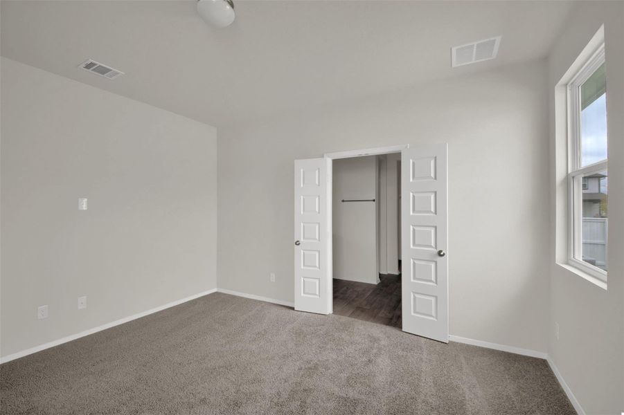Unfurnished bedroom featuring carpet floors and baseboards