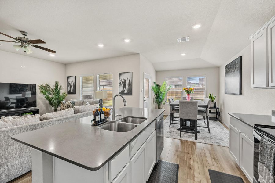Seamlessly integrating a contemporary kitchen, dining area, and living space, this open-concept layout creates an inviting environment.