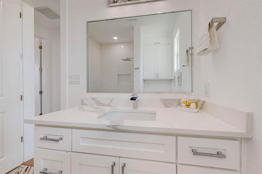 Bathroom with walk in shower and vanity