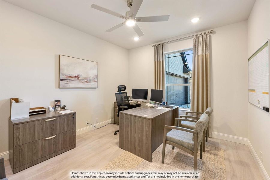 Home office with wood desk, dual monitors, ceiling fan, and hardwood floors