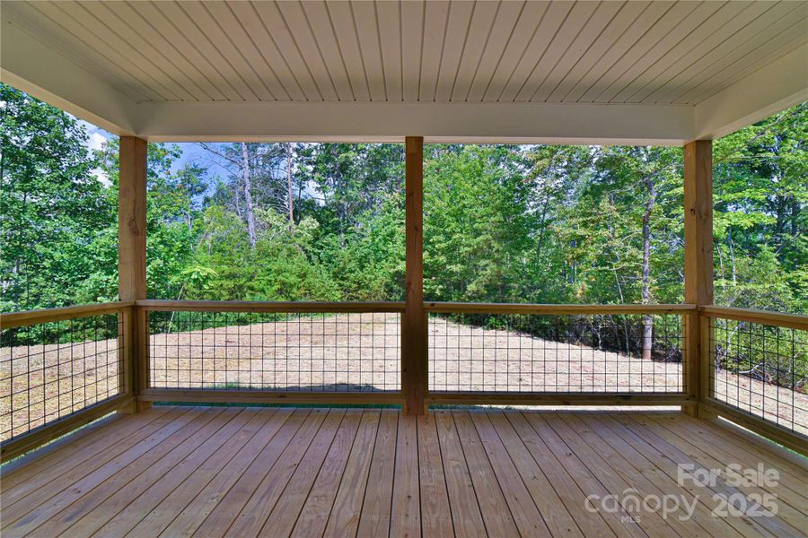 Back deck surrounded by trees.