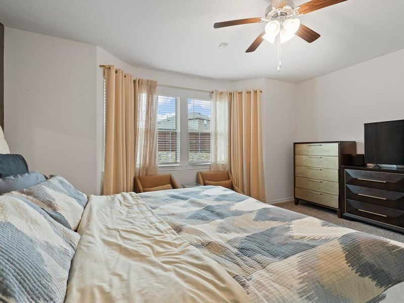 Carpeted bedroom with ceiling fan