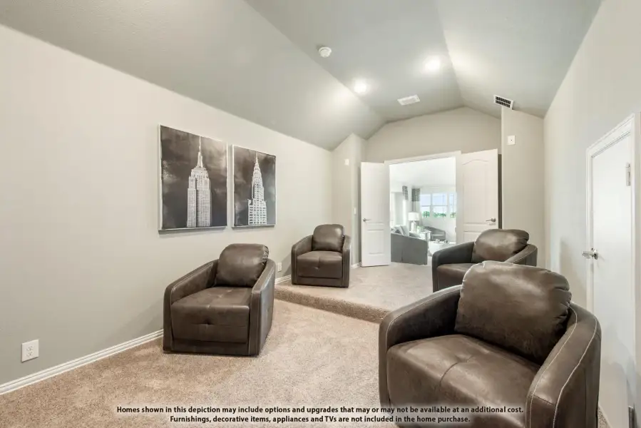 Media room with vaulted ceiling, carpet flooring, and four brown leather chairs arranged in a row Media room with vaulted ceiling, carpet flooring, and four brown leather chairs arranged in a row