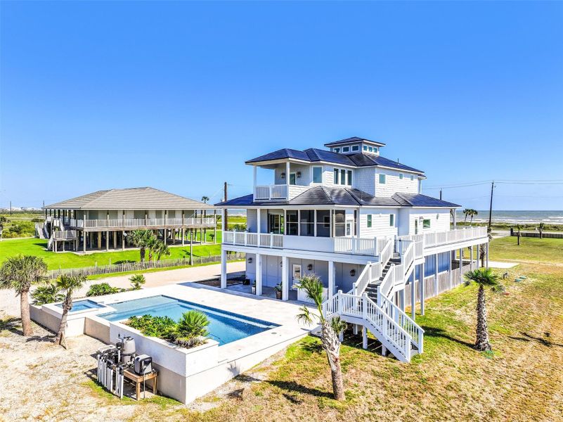 From this angle, the home and sparkling saltwater pool come together in perfect harmony. Step outside to enjoy morning coffee on the balcony, afternoons by the pool, or sunsets from the porch. Every view invites you to relax, entertain, and fully embrace the coastal vacation lifestyle.