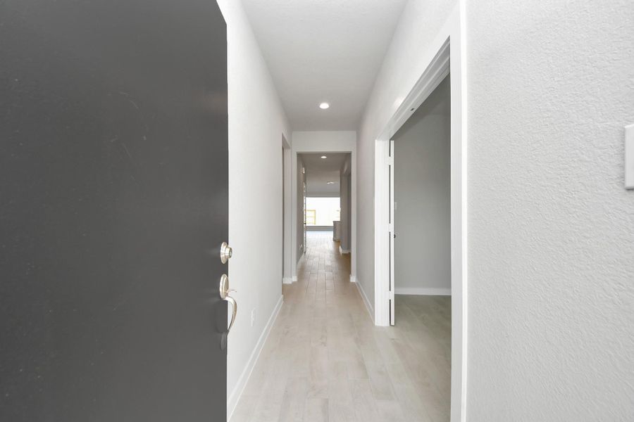 As you step into the threshold of this luxurious home, you'll soon be welcomed by an elegant glass door (to be installed). Inside, soaring ceilings amplify the spaciousness, while the refined wood-look tile flooring and oversized baseboards exude sophistication and charm.