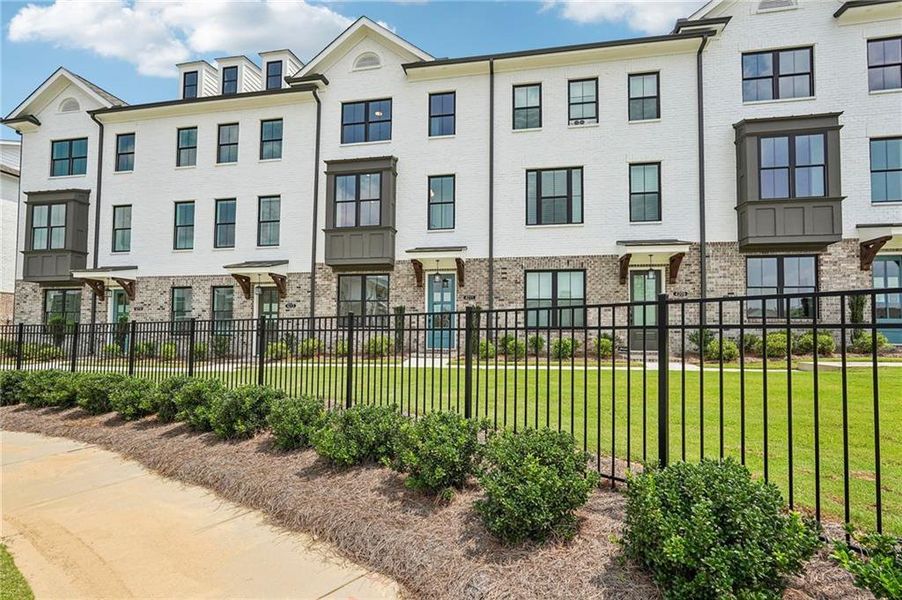 Front exterior of a new home in Millcroft Townhomes, Buford, GA, highlighting curb appeal (Image 2). Front exterior of a new home in Millcroft Townhomes, Buford, GA, highlighting curb appeal (Image 2).