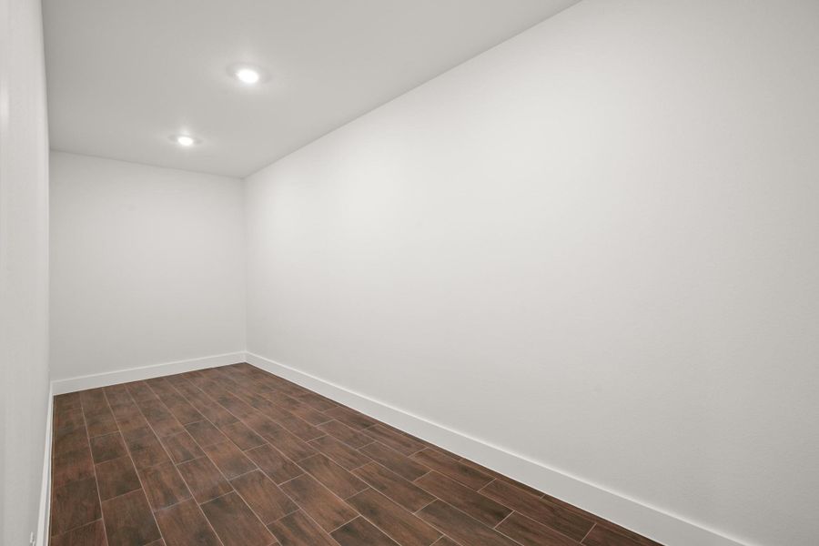 Unfurnished room featuring wood tiled floors and recessed lighting