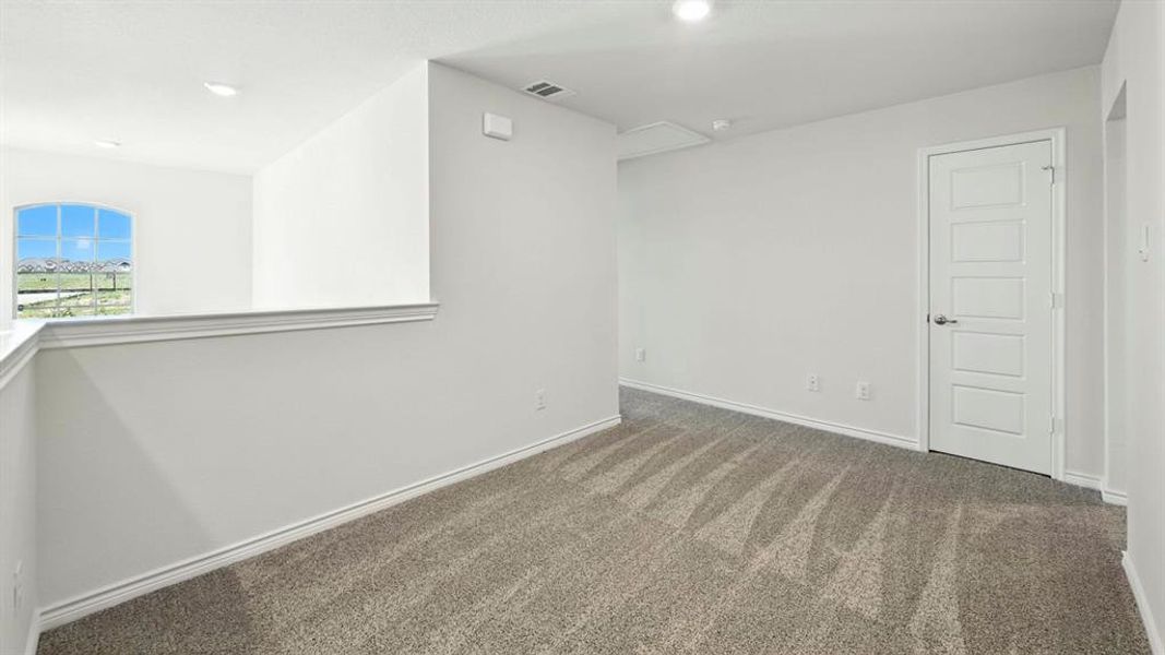 Empty room with carpet floors and recessed lighting