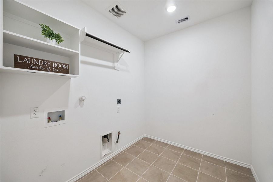 You know those laundry rooms where you can barely fit in the washer and dryer? Well, this is definitely NOT one of those. There is room for a table or possibly a refrigerator in this laundry room.