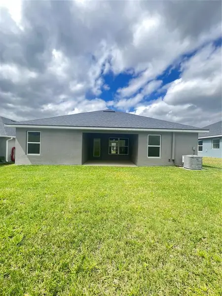 Exterior details and patio area of a home in Abbey Glen, Dade City (Image 3).