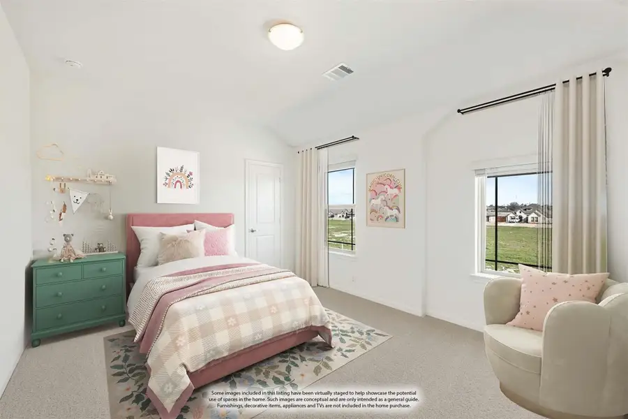 Children's bedroom with vaulted ceiling, pink bed frame, carpet flooring, and two windows with outdoor views