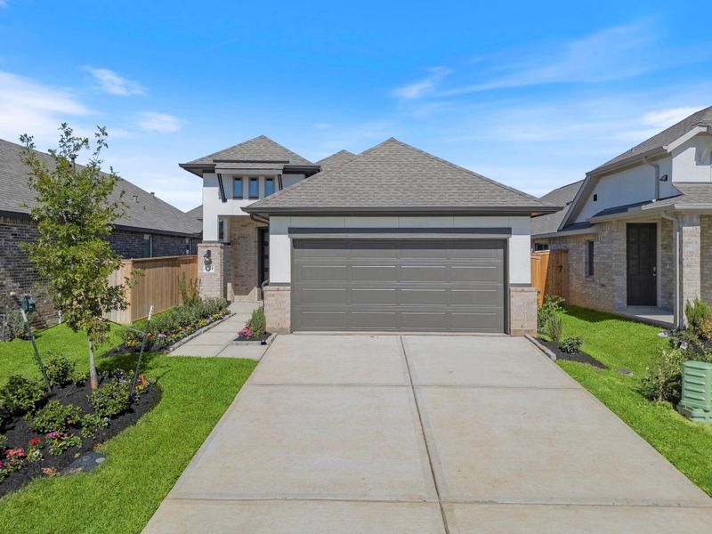 Front exterior of a new home in Grand Central Park, Conroe, TX, highlighting curb appeal (Image 22). Front exterior of a new home in Grand Central Park, Conroe, TX, highlighting curb appeal (Image 22).