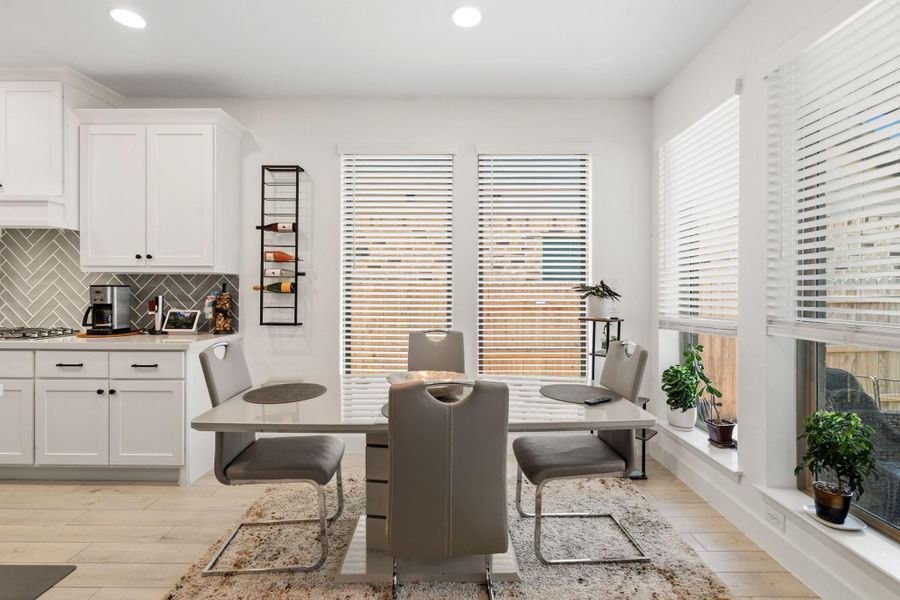 Sunny breakfast nook overlooking the backyard and outdoor living space