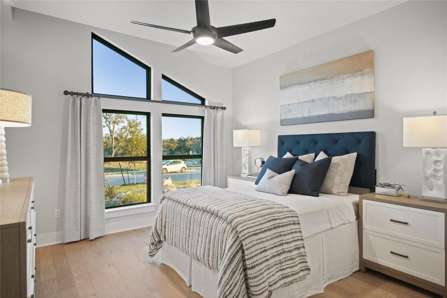 Bedroom featuring light wood-style floors, ceiling fan, and a view