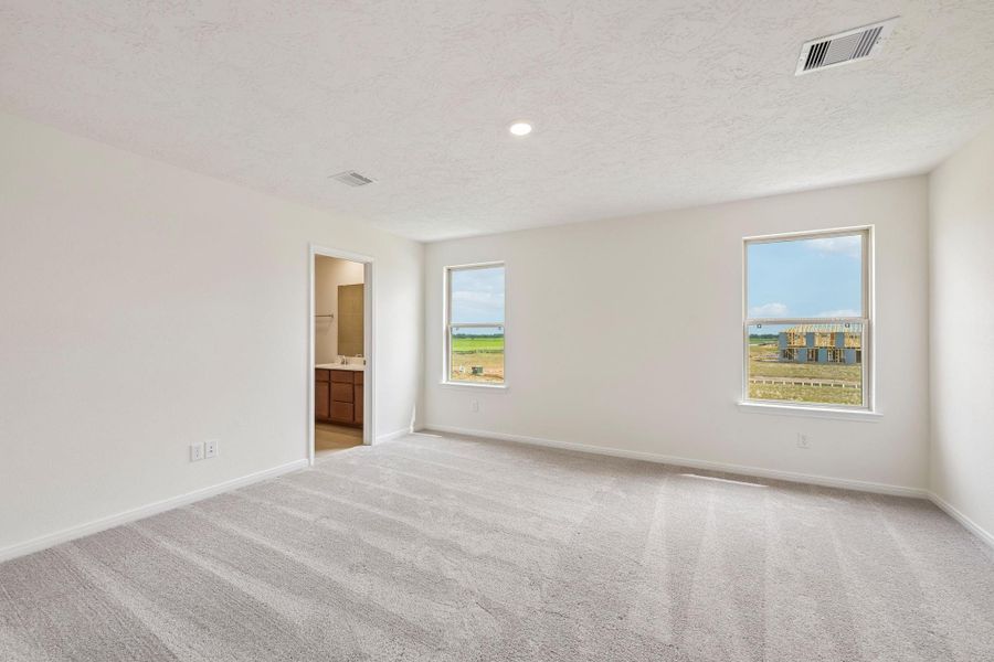 Relax and recharge in this stunning primary suite! Enjoy the comfort of plush carpeting, neutral-toned walls, high ceilings, recessed lighting, and large windows that fill the room with natural light. Relax and recharge in this stunning primary suite! Enjoy the comfort of plush carpeting, neutral-toned walls, high ceilings, recessed lighting, and large windows that fill the room with natural light.