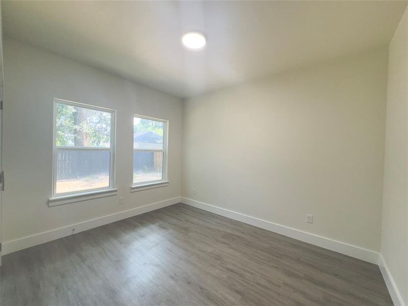 Empty room featuring dark hardwood / wood-style floors