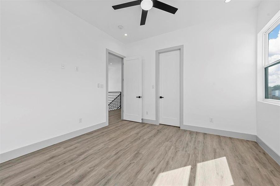 Unfurnished bedroom featuring light wood-type flooring and ceiling fan