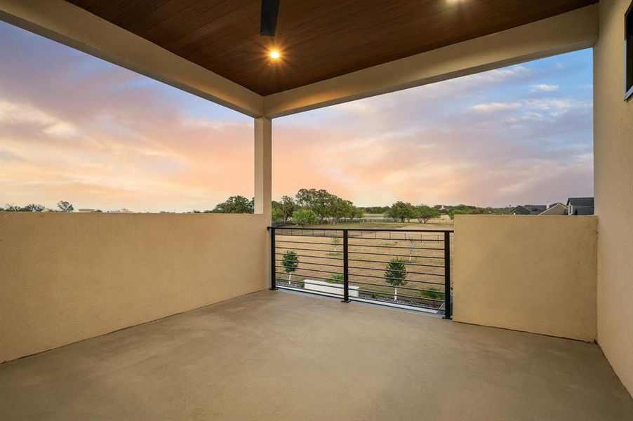 Covered balcony with serene sunset views. Covered balcony with serene sunset views.