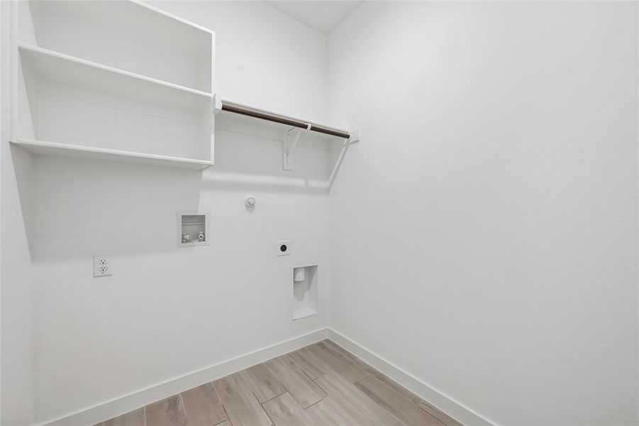 Laundry room with gas dryer hookup, light wood-type flooring, washer hookup, and electric dryer hookup