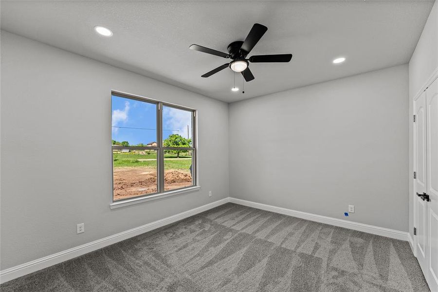 Carpeted spare room featuring ceiling fan and recessed lighting Carpeted spare room featuring ceiling fan and recessed lighting