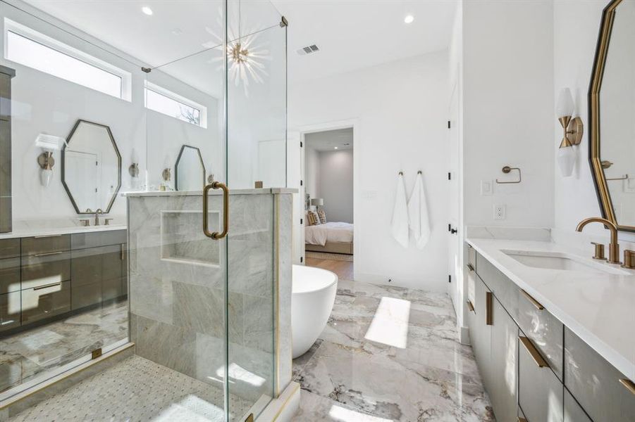 Primary bathroom with dual vanities, free standing tub and spacious shower. Primary bathroom with dual vanities, free standing tub and spacious shower.