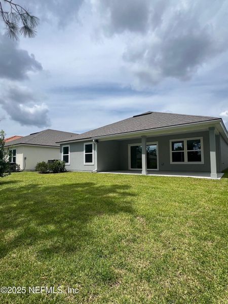 Front exterior of a new home in American Village, Palm Coast, FL, highlighting curb appeal (Image 28).