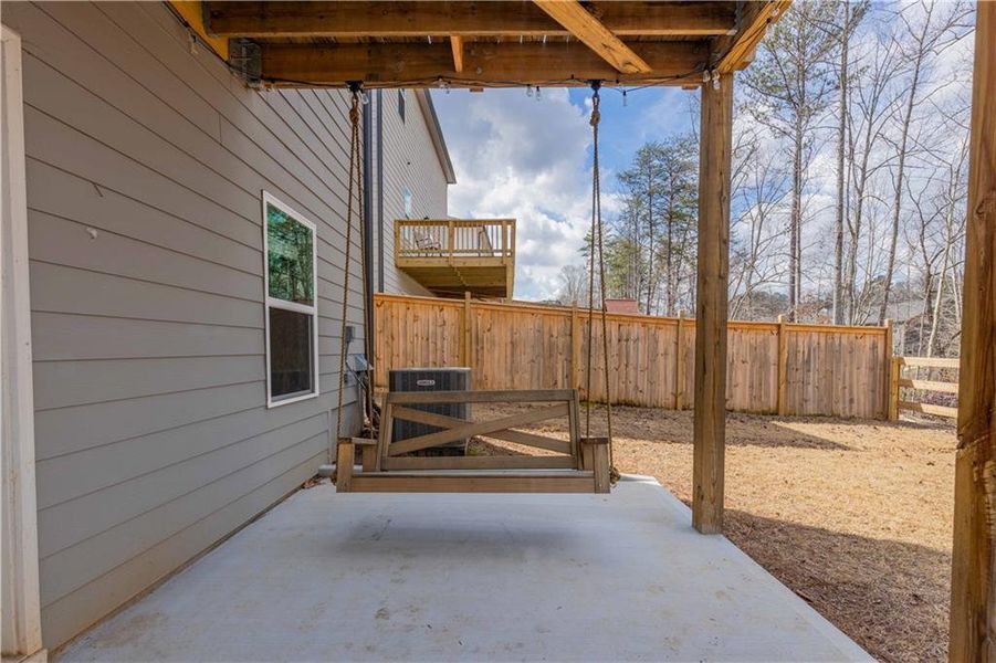 Exterior details and patio area of a home in Creekside at Farmers Crossing, Ball Ground (Image 24).