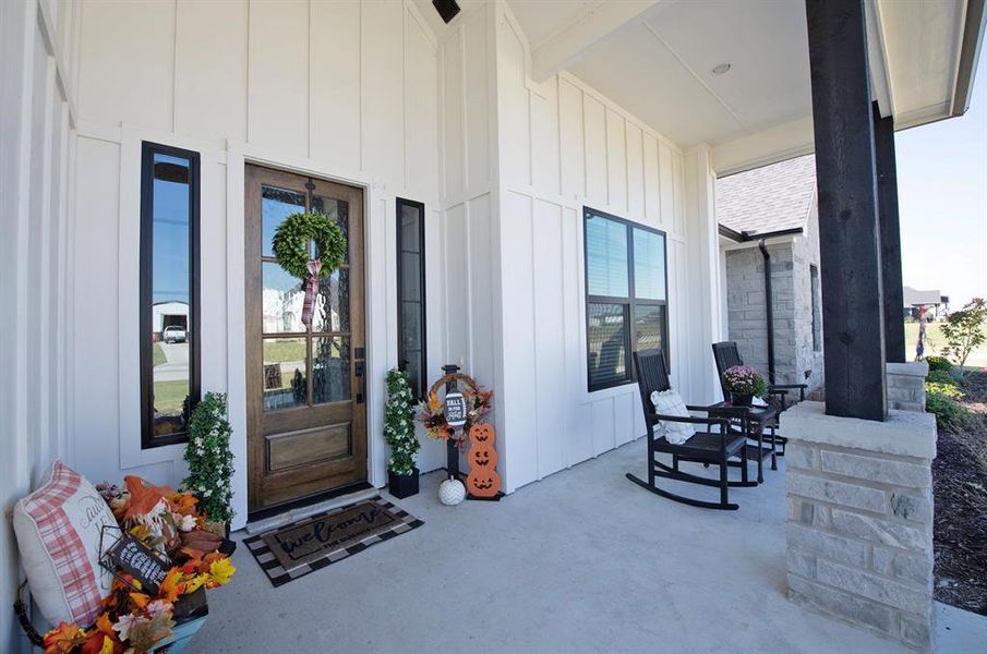 Property entrance with a porch and board and batten siding