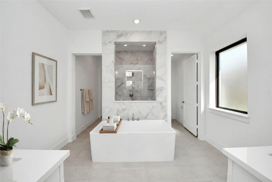 The centerpiece of this contemporary primary bath is the deep, freestanding bathtub, offering an ideal spot for relaxation with a unique view into the walk-in shower. The centerpiece of this contemporary primary bath is the deep, freestanding bathtub, offering an ideal spot for relaxation with a unique view into the walk-in shower.