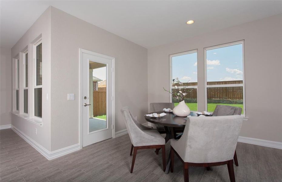 *Model Representation - Dining area off kitchen with large windows