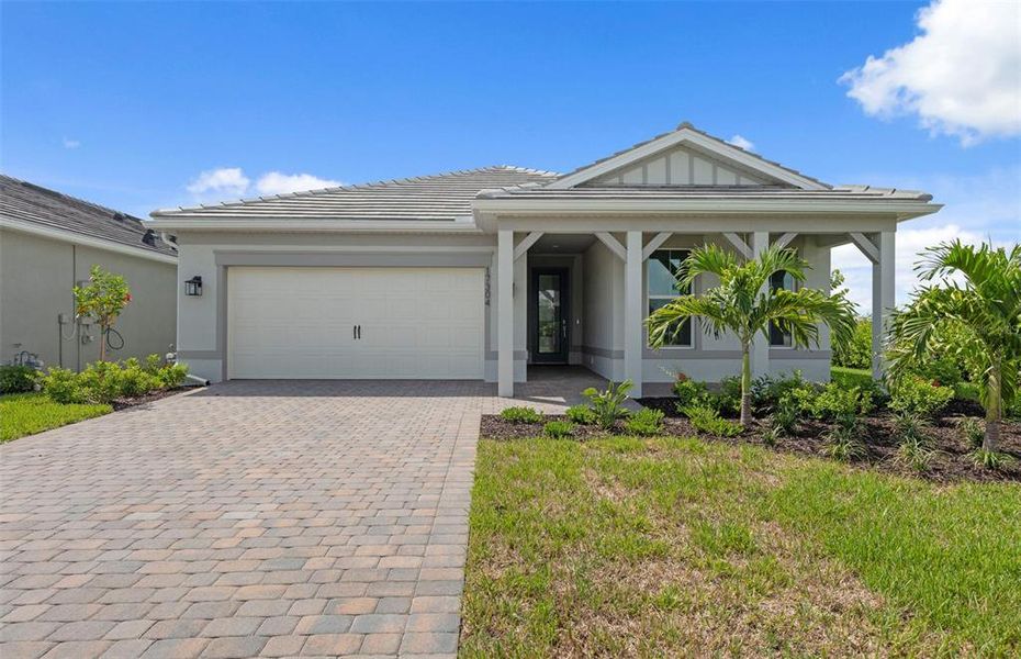 Front exterior of a new home in Shores at Stillwater, Englewood, FL, highlighting curb appeal (Image 2). Front exterior of a new home in Shores at Stillwater, Englewood, FL, highlighting curb appeal (Image 2).