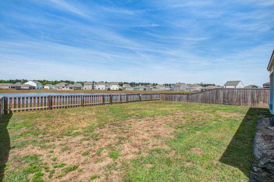 Exterior details and patio area of a home in Pine Hills at Cane Bay, Summerville (Image 24).