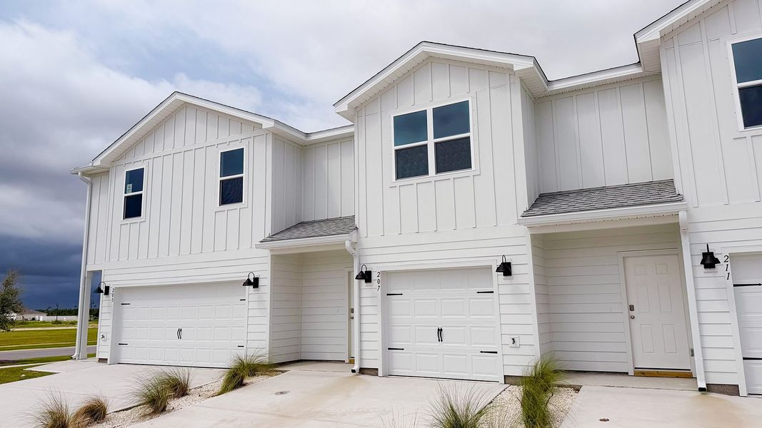 Front exterior of a new home in Salt Creek Townhomes at Mexico Beach, Mexico Beach, FL, highlighting curb appeal (Image 19). Front exterior of a new home in Salt Creek Townhomes at Mexico Beach, Mexico Beach, FL, highlighting curb appeal (Image 19).