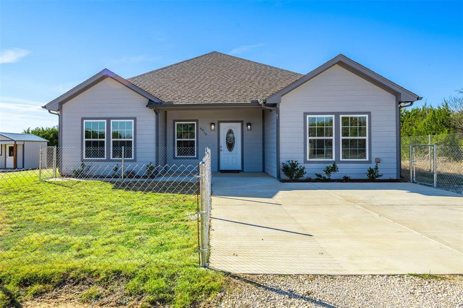 Single story home featuring a front lawn