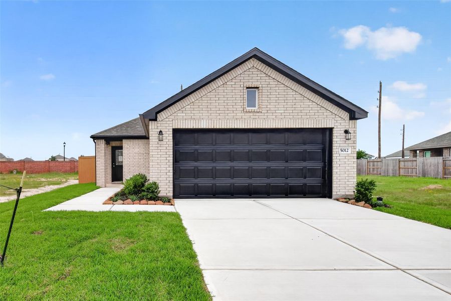 Front exterior of a new home in Sunterra, Katy, TX, highlighting curb appeal (Image 22).