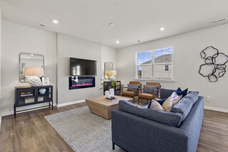 A living room with a couch and a tv.