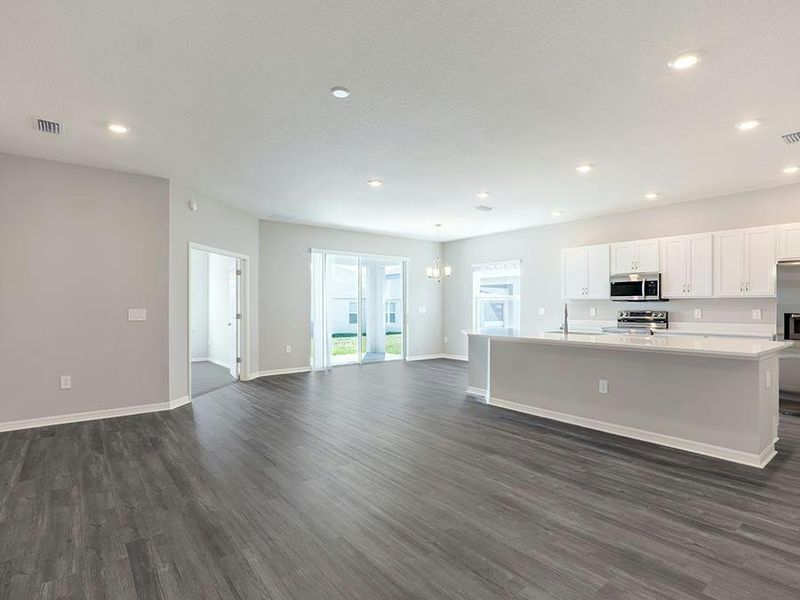 The open living area features low-maintenance LVP flooring - Photos showcase a home with similar finishes, not the actual home for sale.