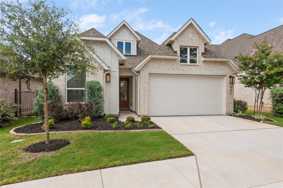 A well-maintained facade with brick and board-and-batten accents creates inviting curb appeal. A well-maintained facade with brick and board-and-batten accents creates inviting curb appeal.