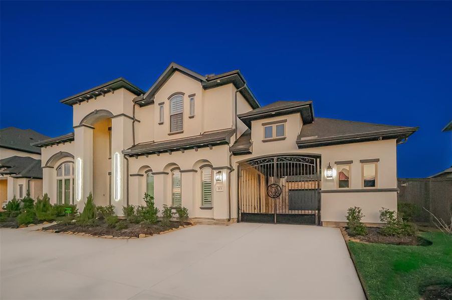 From the moment you arrive, you are greeted by a stunning full-stucco exterior in a rare and rich neutral palette, perfectly complemented by a gracefully curved driveway. The double-door porch entryway invites you into a world of sophistication and style.