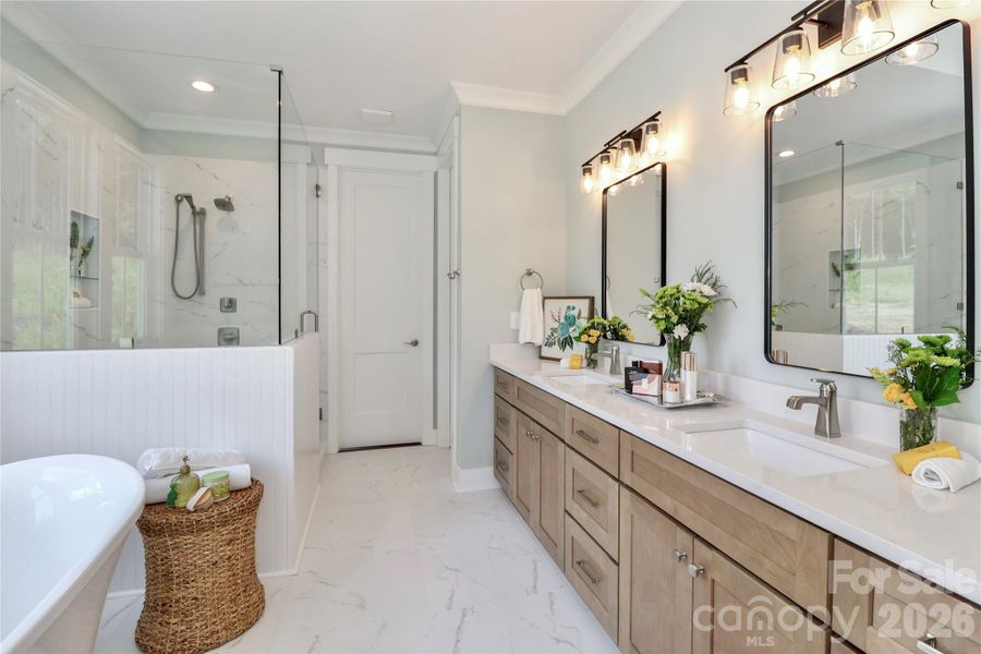 This bathroom offers a luxurious and relaxing experience. The design elements incorporate calming colors, natural materials, while highlighting features including a soaking tub, a rain shower, and shower seating. This bathroom offers a luxurious and relaxing experience. The design elements incorporate calming colors, natural materials, while highlighting features including a soaking tub, a rain shower, and shower seating.