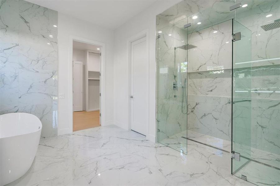 Bathroom with visible vents, marble finish floor, a marble finish shower, and a soaking tub