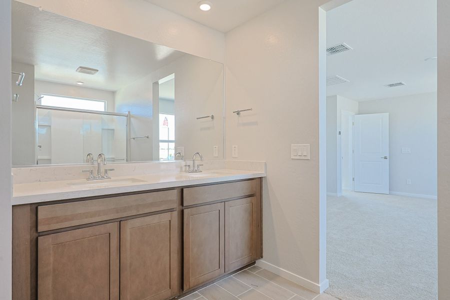 A bathroom with a large mirror.