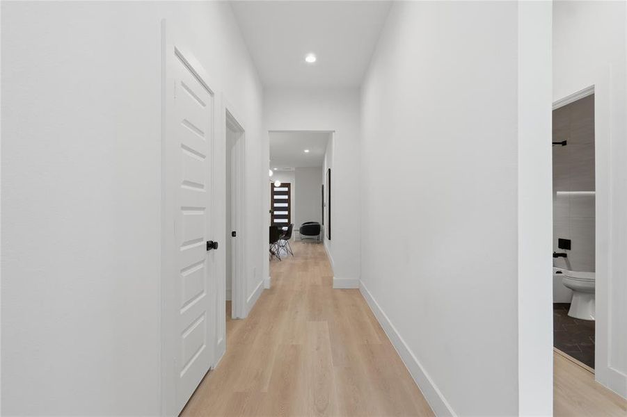 Hallway with recessed lighting and light wood finished floors Hallway with recessed lighting and light wood finished floors