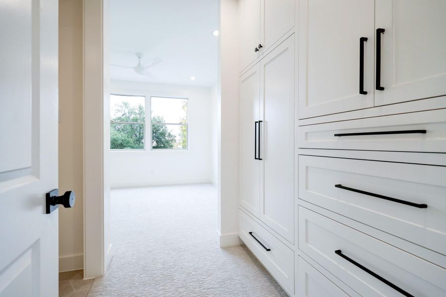 The secondary bedroom features a built in closet storage system and a private vanity with shared shower/tub combo with Secondary Bedroom #1. *Previous Project*