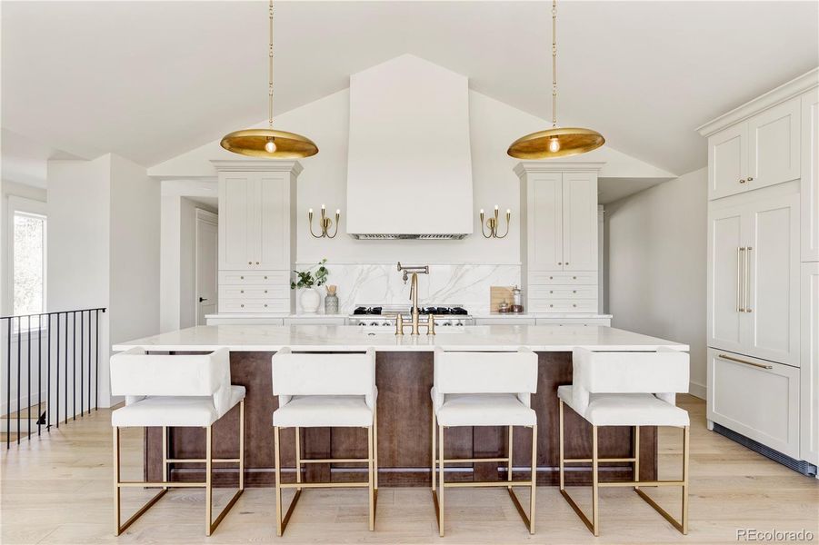 Custom hood, quartz countertops, and integrated refrigerator